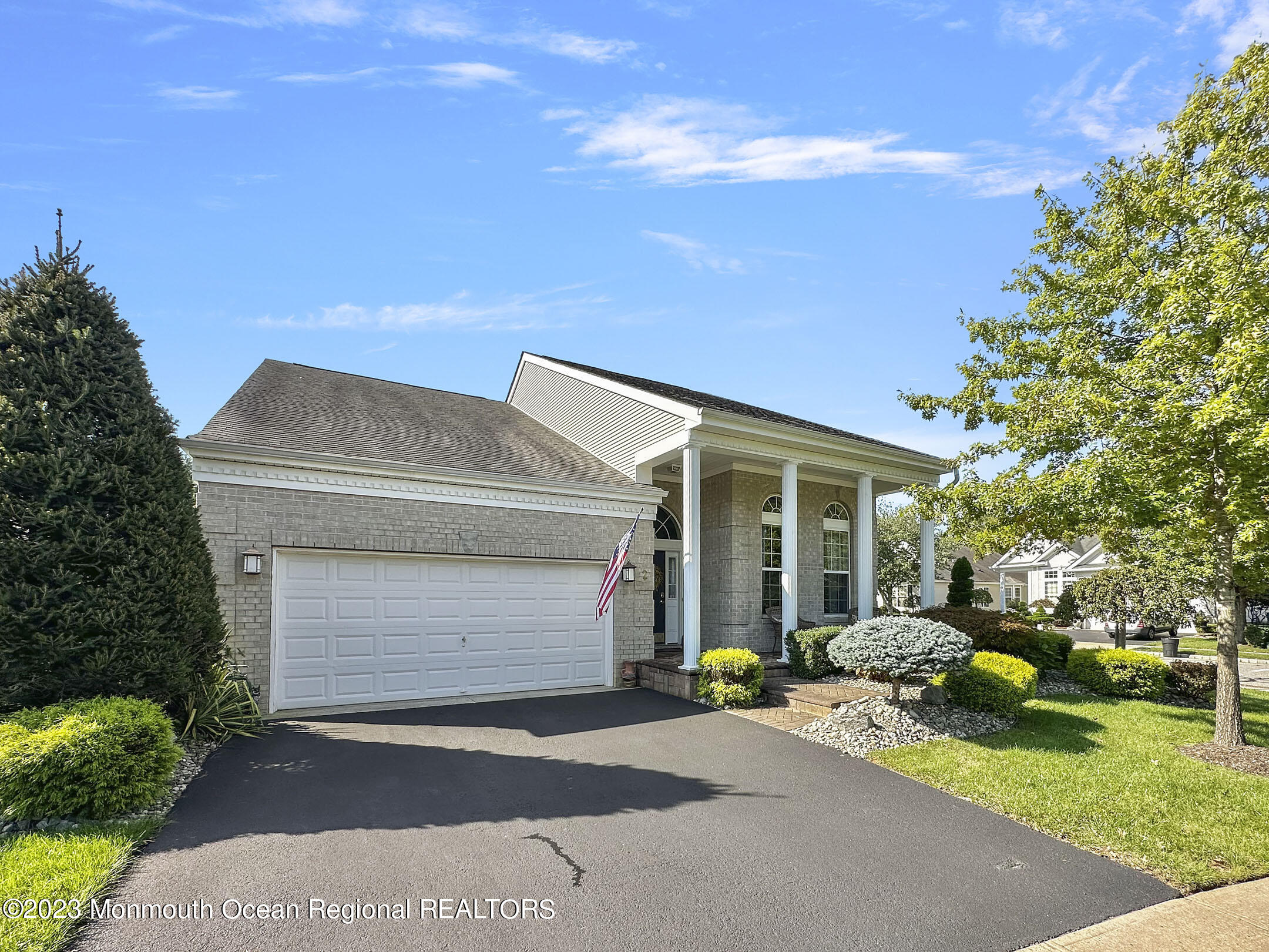 2 Arcaro Road Manalapan, NJ 07726 - Photo 2 of 42 a front view of a house with a yard and garage
