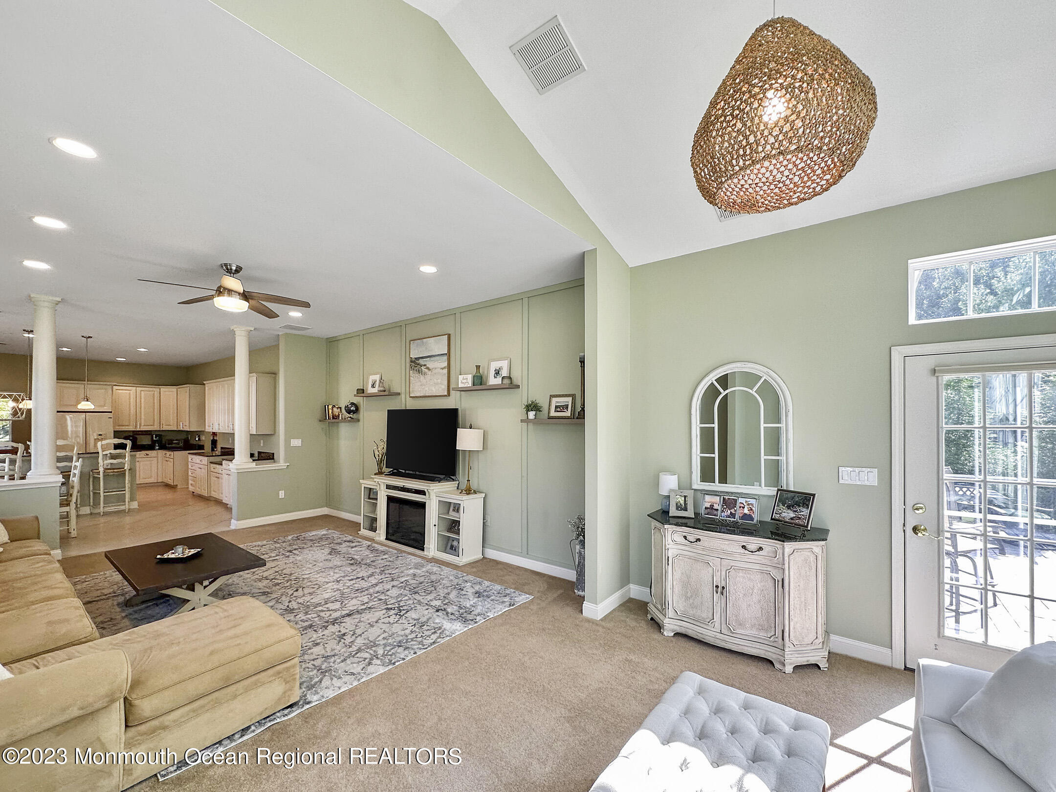 2 Arcaro Road Manalapan, NJ 07726 - Photo 26 of 42 a living room with furniture a dining table and a fireplace