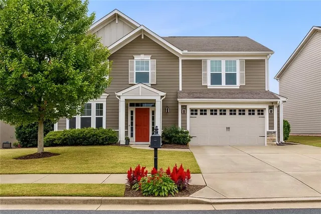 a front view of a house with a yard and garage