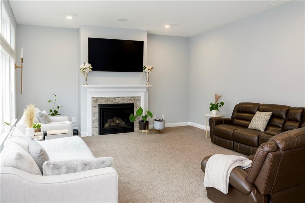 830 Commerce Trail Canton, GA 30114 - Photo 11 of 32 a living room with furniture a flat screen tv and a fireplace