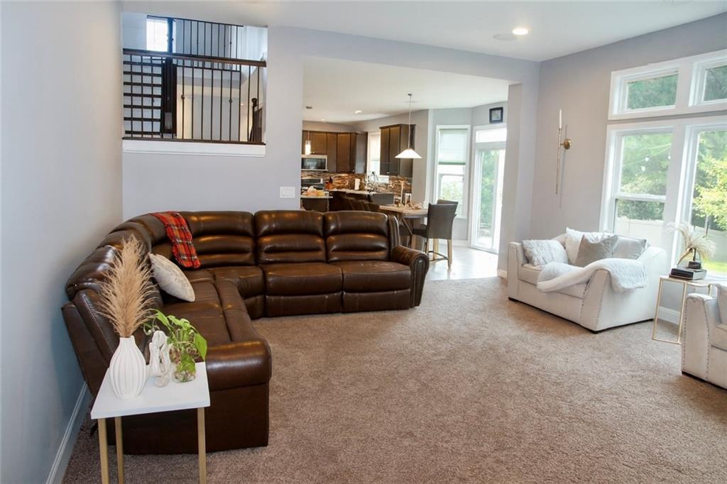 830 Commerce Trail Canton, GA 30114 - Photo 12 of 32 a living room with furniture ceiling fan and a window