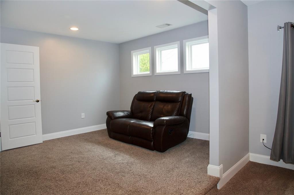830 Commerce Trail Canton, GA 30114 - Photo 22 of 32 a living room with furniture and a window
