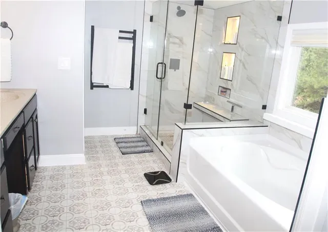 a bathroom with a tub and a shower