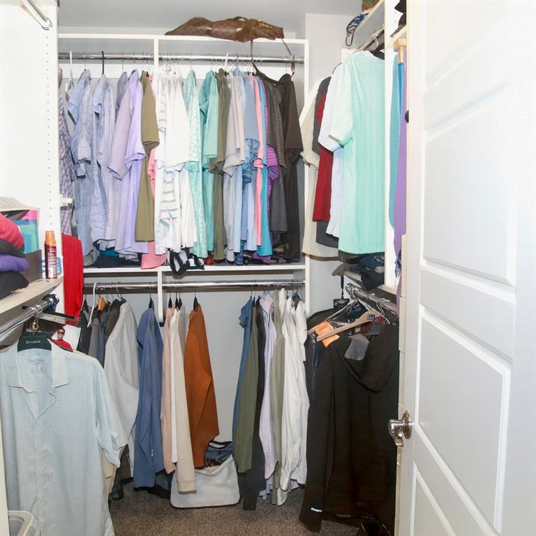 830 Commerce Trail Canton, GA 30114 - Photo 26 of 32 a view of walk in closet with clothes and shoes