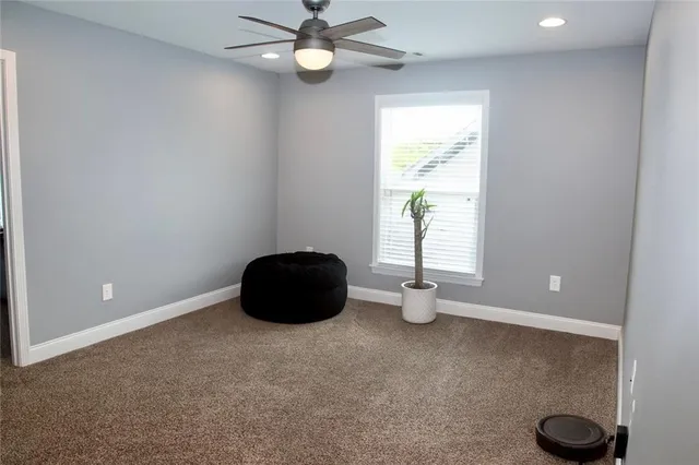 a bathroom with a granite countertop toilet sink and a mirror