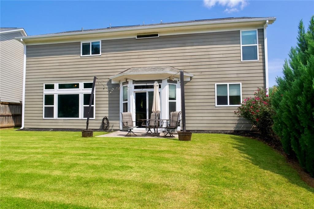 830 Commerce Trail Canton, GA 30114 - Photo 30 of 32 a view of a house with a yard and sitting area