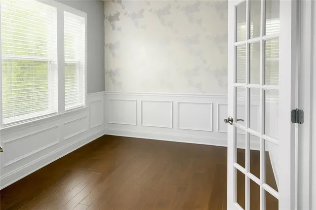 a view of a room with wooden floor and windows