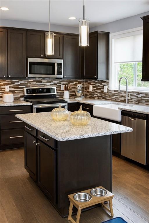 830 Commerce Trail Canton, GA 30114 - Photo 6 of 32 a kitchen with kitchen island granite countertop a sink appliances and cabinets