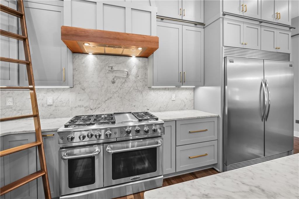 211 McMichael Road Carnegie, PA 15106 - Photo 11 of 50 a kitchen with stainless steel appliances wooden cabinets and a stove top oven