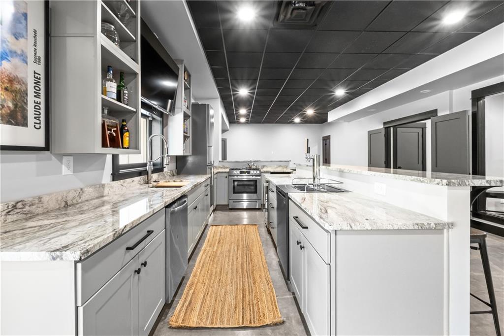 211 McMichael Road Carnegie, PA 15106 - Photo 37 of 50 a large kitchen with stainless steel appliances granite countertop a sink and counter space