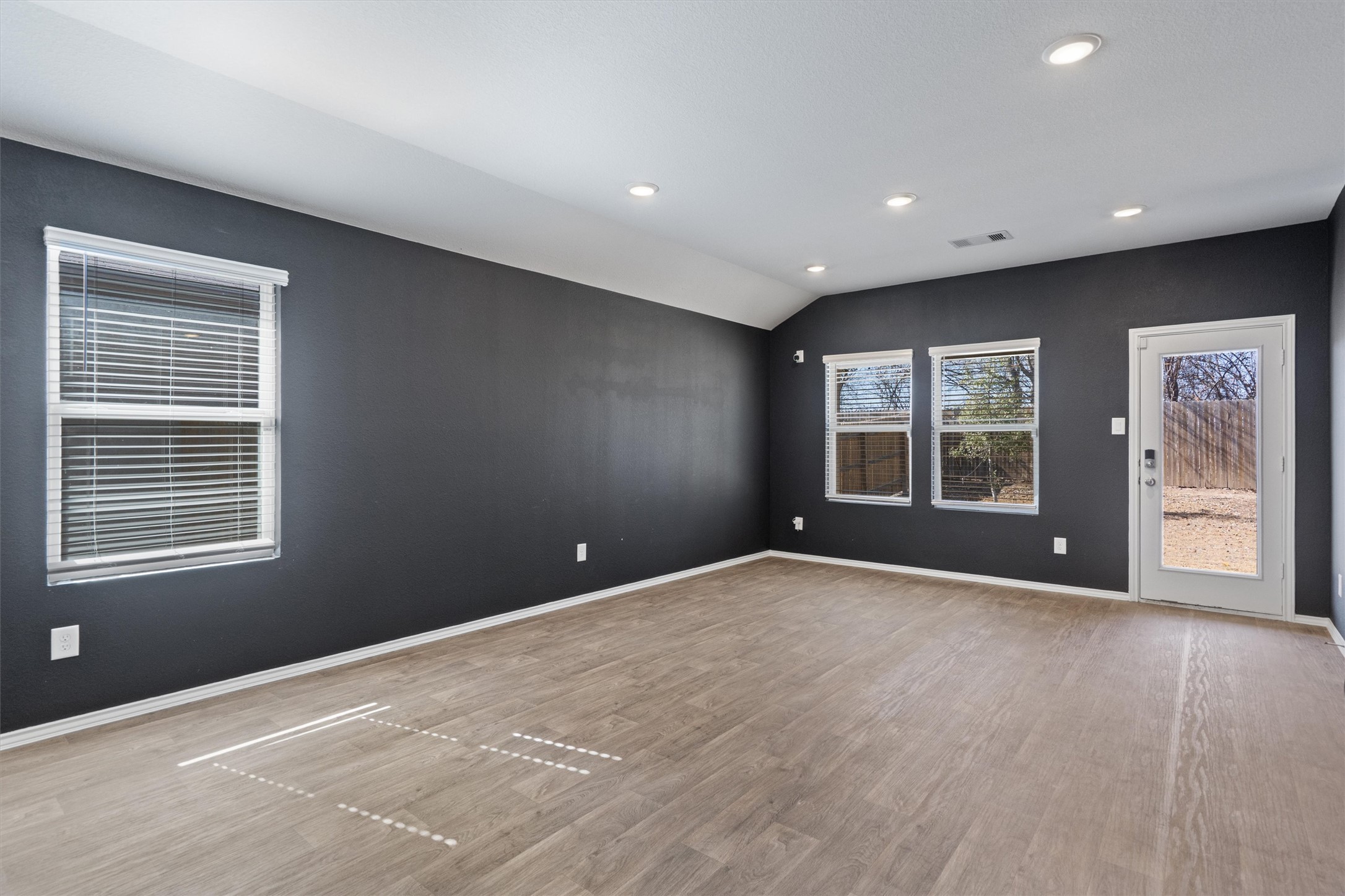 352 Sickle Loop Uhland, TX 78640 - Photo 15 of 36 Spacious living area with high ceilings and recessed lighting.
