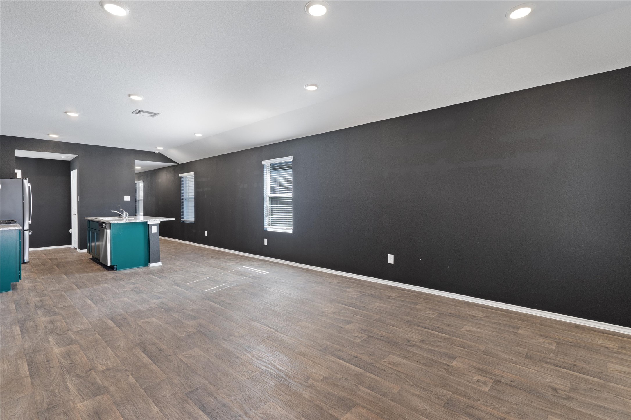 352 Sickle Loop Uhland, TX 78640 - Photo 18 of 36 Open-concept living area with recessed lighting and view toward kitchen and entry.