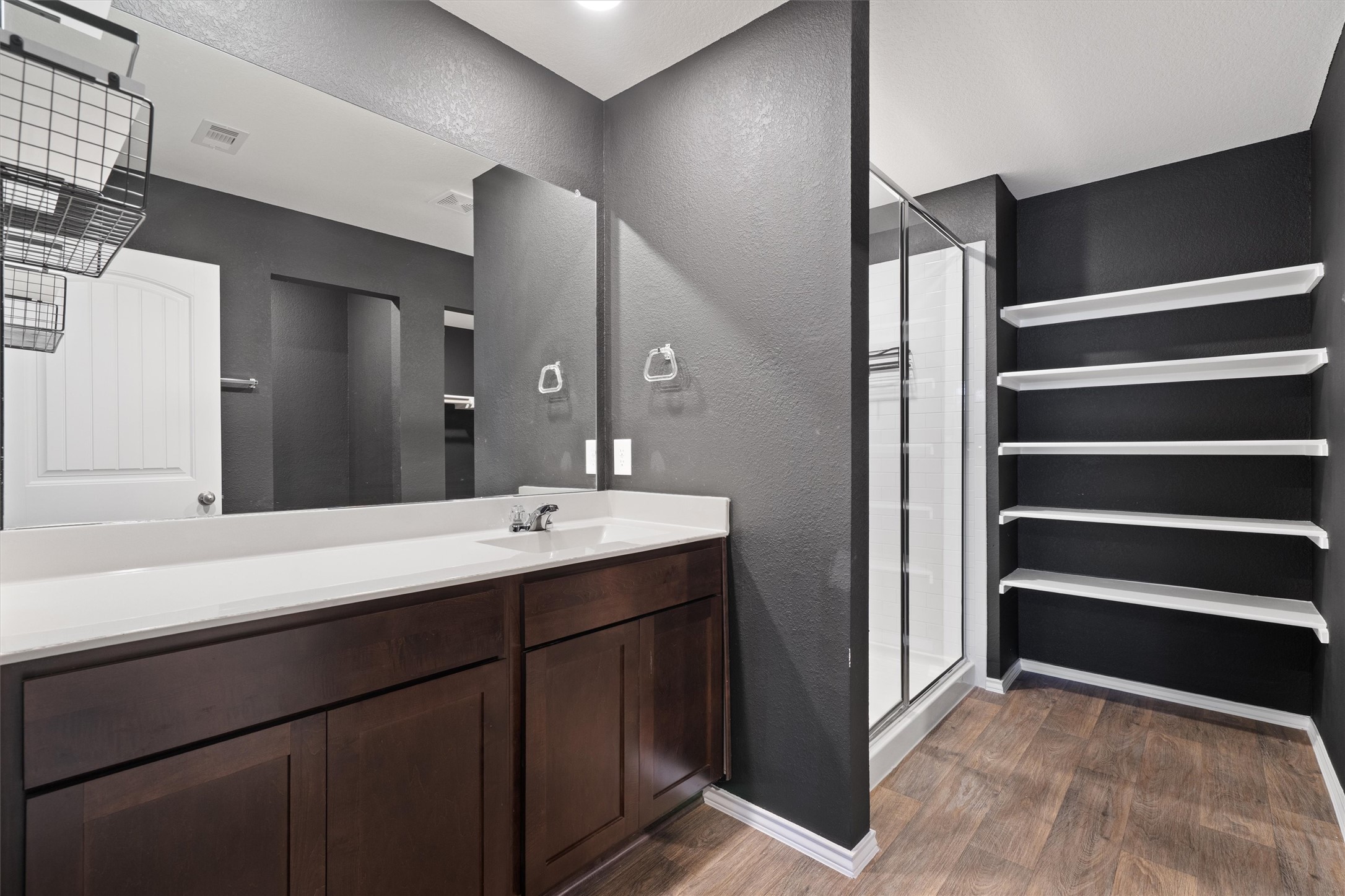 352 Sickle Loop Uhland, TX 78640 - Photo 22 of 36 Primary bathroom with vanity and walk-in shower.