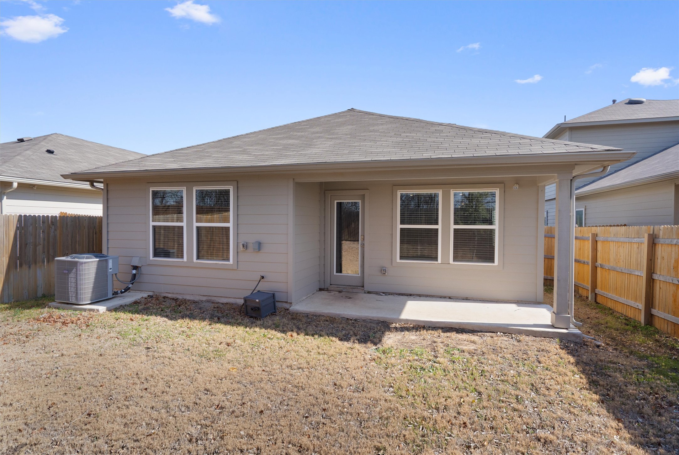 352 Sickle Loop Uhland, TX 78640 - Photo 31 of 36 Rear exterior view showing covered patio and fenced yard.