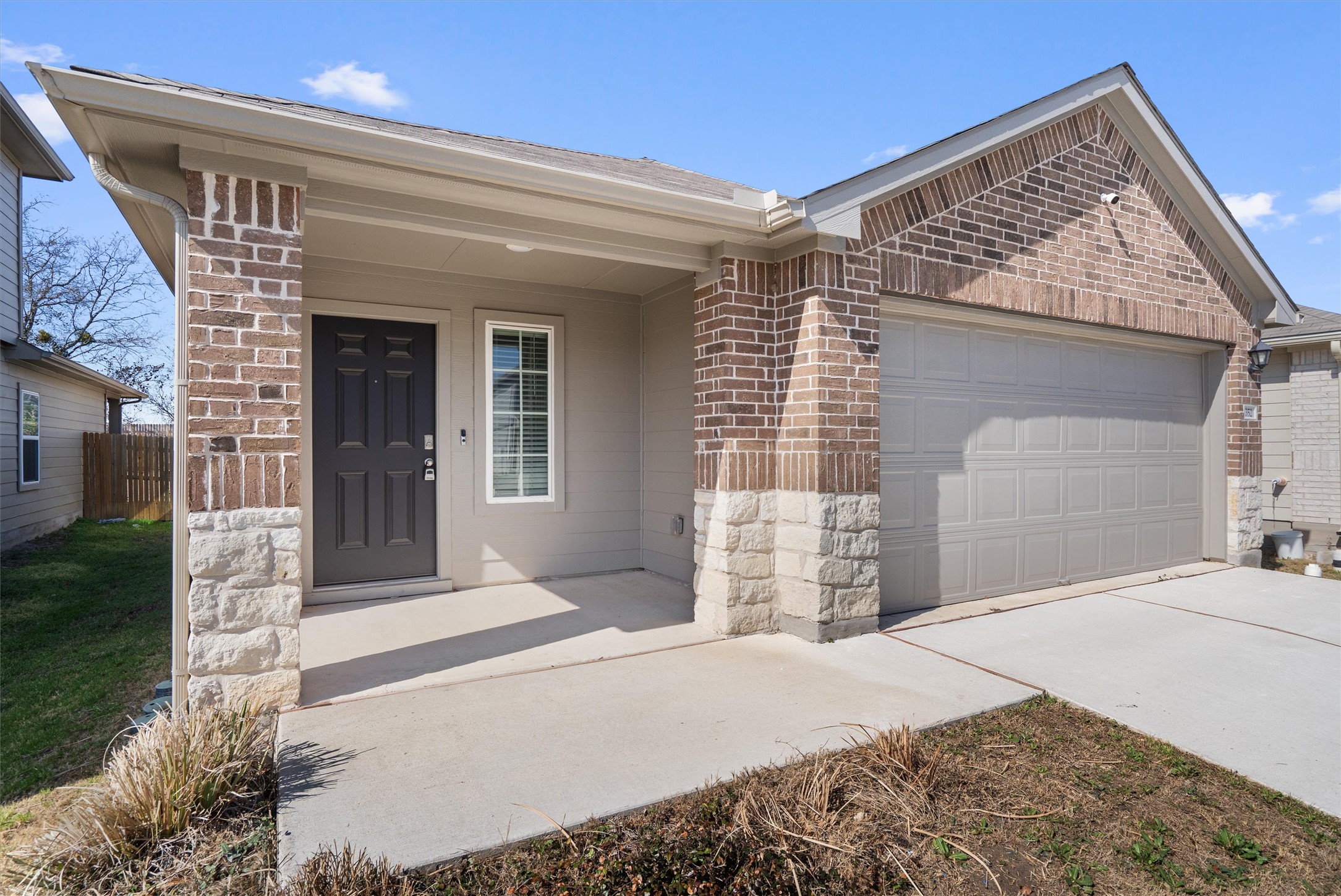 352 Sickle Loop Uhland, TX 78640 - Photo 5 of 36 Covered front porch with stone columns and recessed entry.