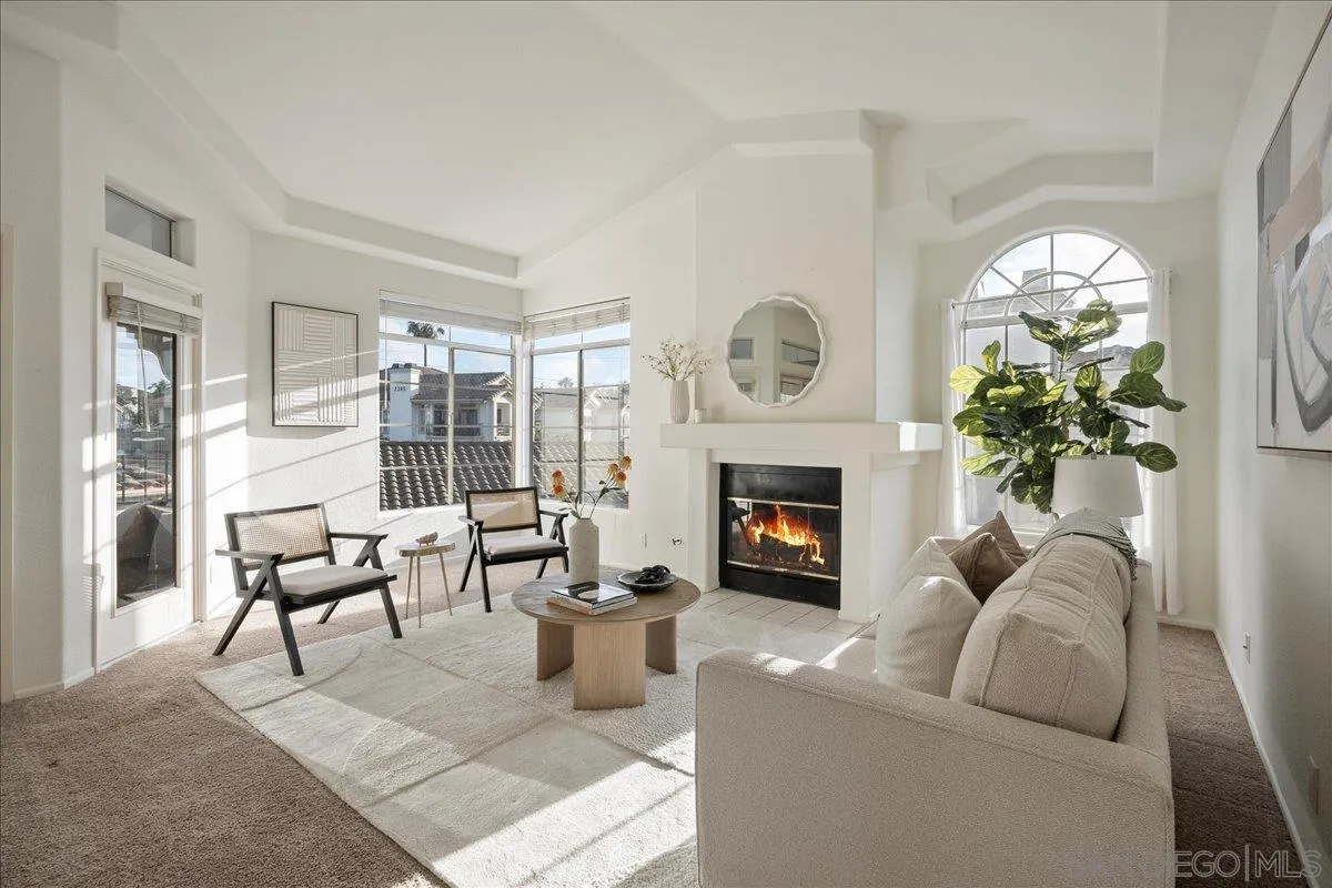 2315 Rancho Del Oro Drive, Unit 14 Oceanside, CA 92056 - Photo 1 of 34 a living room with furniture a fireplace and a large window