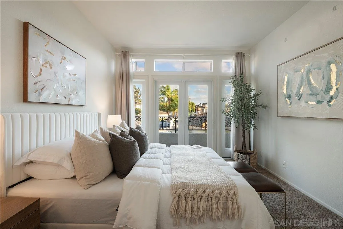 2315 Rancho Del Oro Drive, Unit 14 Oceanside, CA 92056 - Photo 11 of 34 a bedroom with a large bed and a painting on the wall