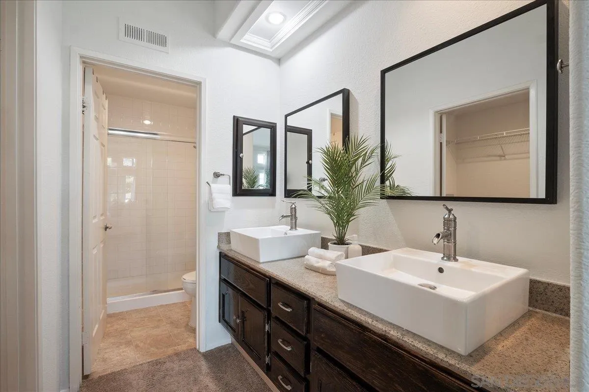 2315 Rancho Del Oro Drive, Unit 14 Oceanside, CA 92056 - Photo 14 of 34 a bathroom with a sink and a mirror