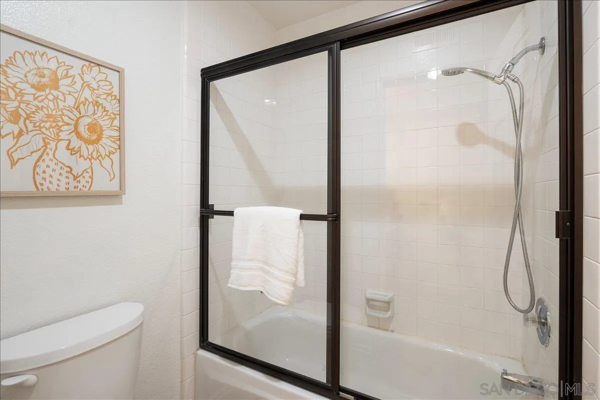 2315 Rancho Del Oro Drive, Unit 14 Oceanside, CA 92056 - Photo 17 of 34 a bathroom with a glass shower door