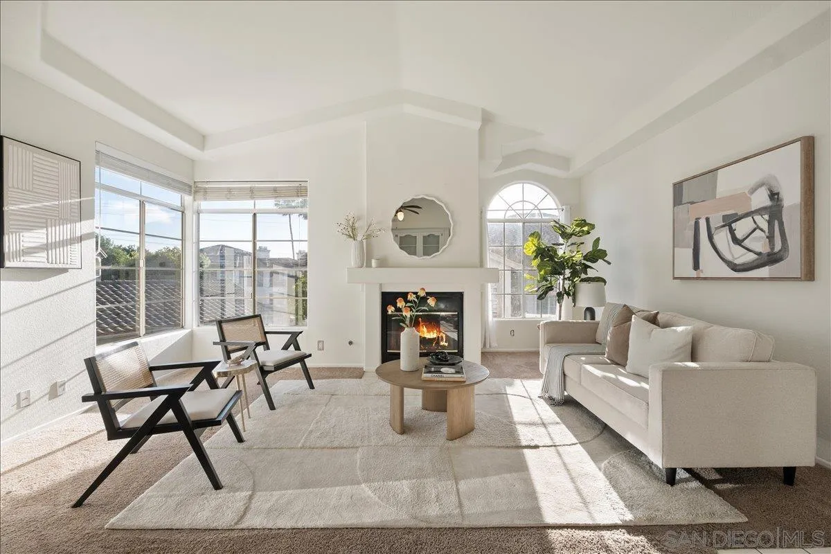 2315 Rancho Del Oro Drive, Unit 14 Oceanside, CA 92056 - Photo 2 of 34 a living room with furniture a fireplace and a floor to ceiling window