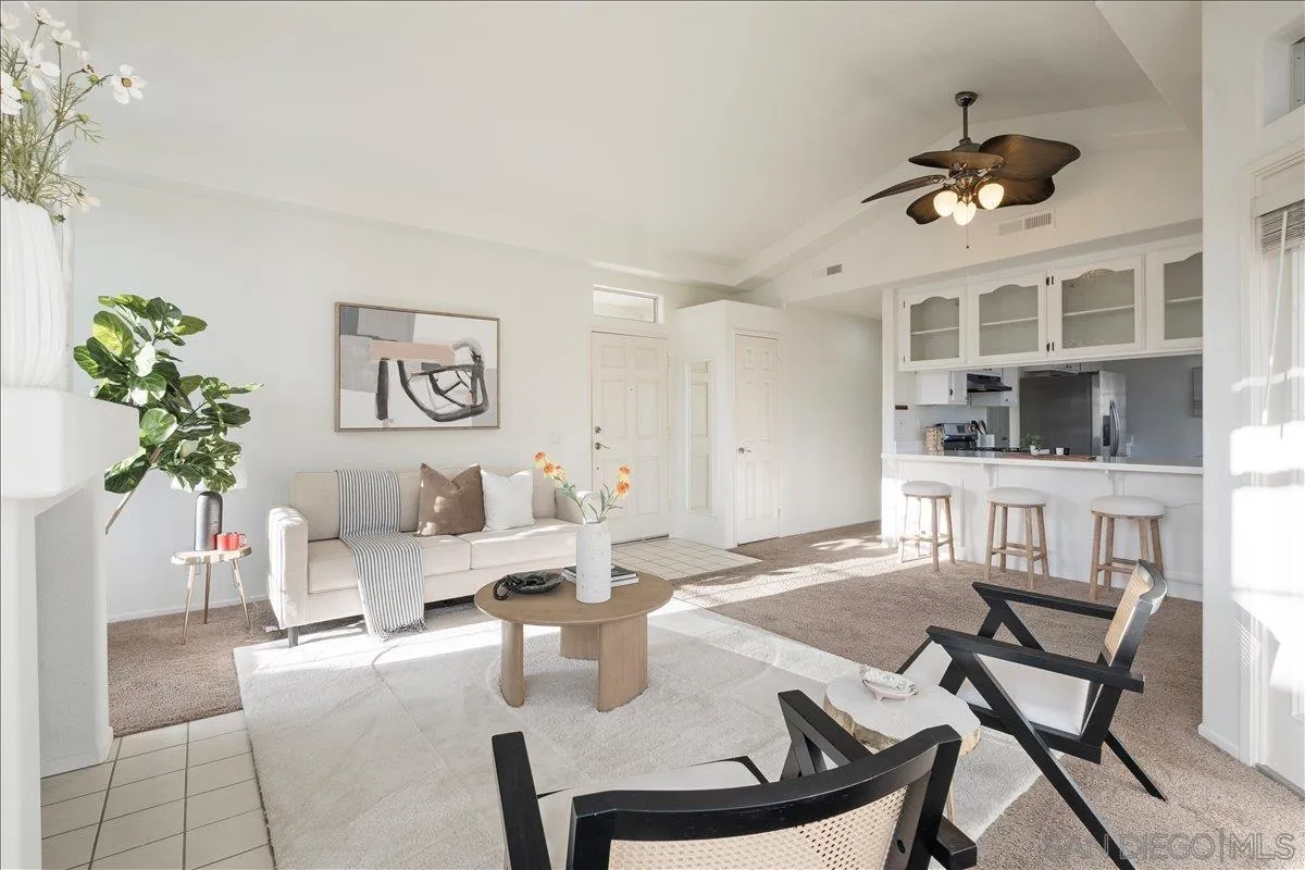 2315 Rancho Del Oro Drive, Unit 14 Oceanside, CA 92056 - Photo 3 of 34 a living room with furniture a chandelier and kitchen view