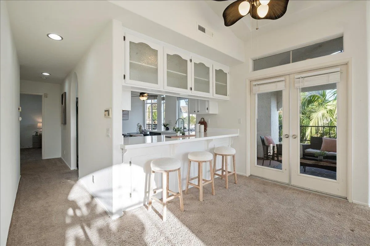 2315 Rancho Del Oro Drive, Unit 14 Oceanside, CA 92056 - Photo 4 of 34 a living room with furniture a dining table and chairs