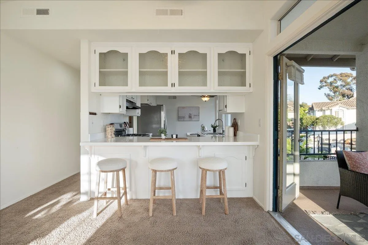2315 Rancho Del Oro Drive, Unit 14 Oceanside, CA 92056 - Photo 5 of 34 a kitchen with a sink and chairs