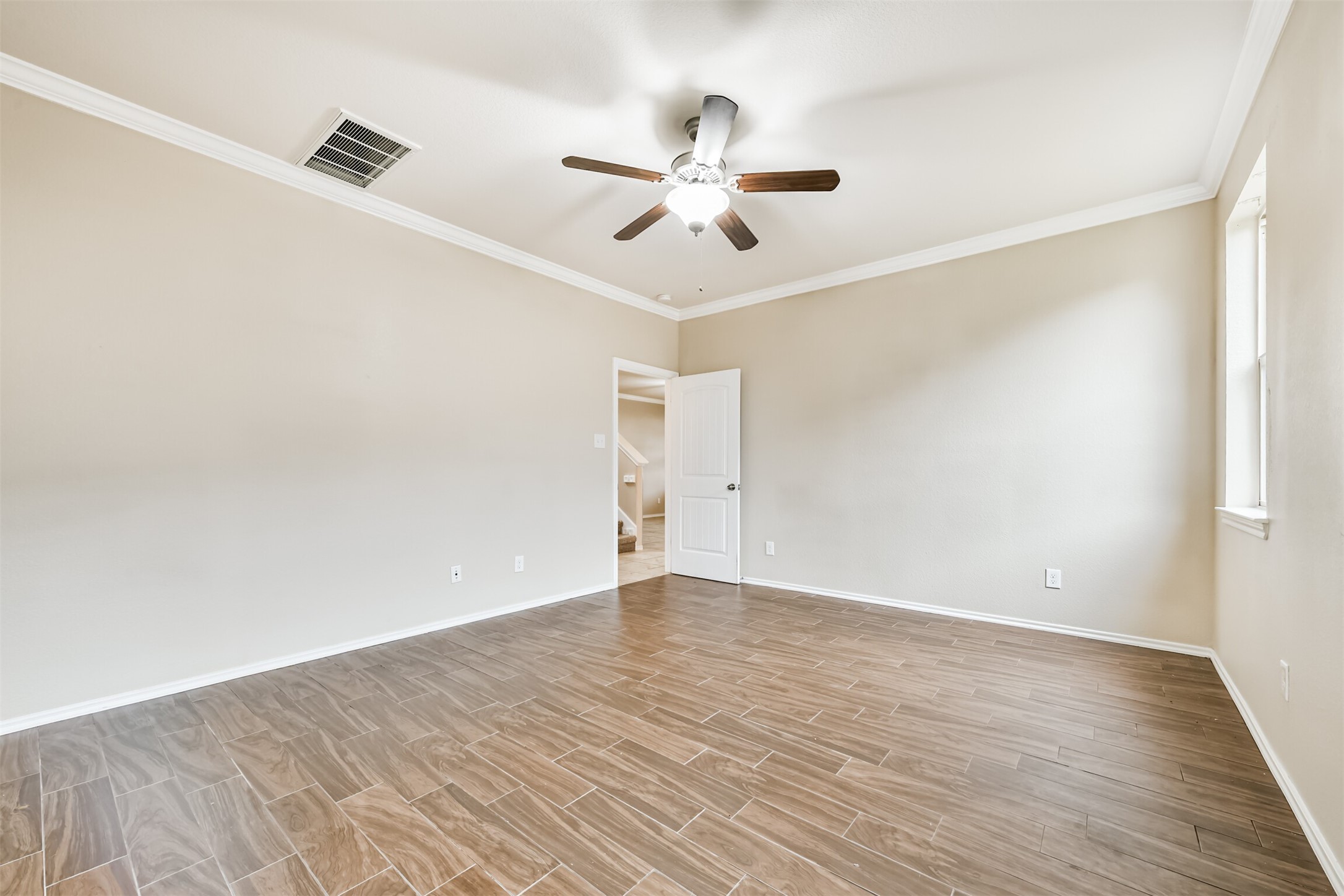3041 Heather Grove Lane Dickinson, TX 77539 - Photo 19 of 37 a view of a room with wooden floor and ceiling fan