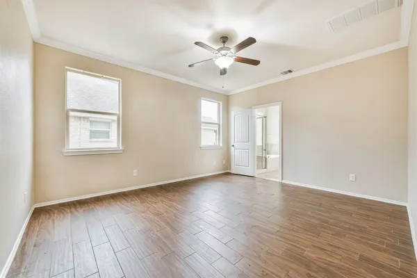 a view of a room with wooden floor and fan