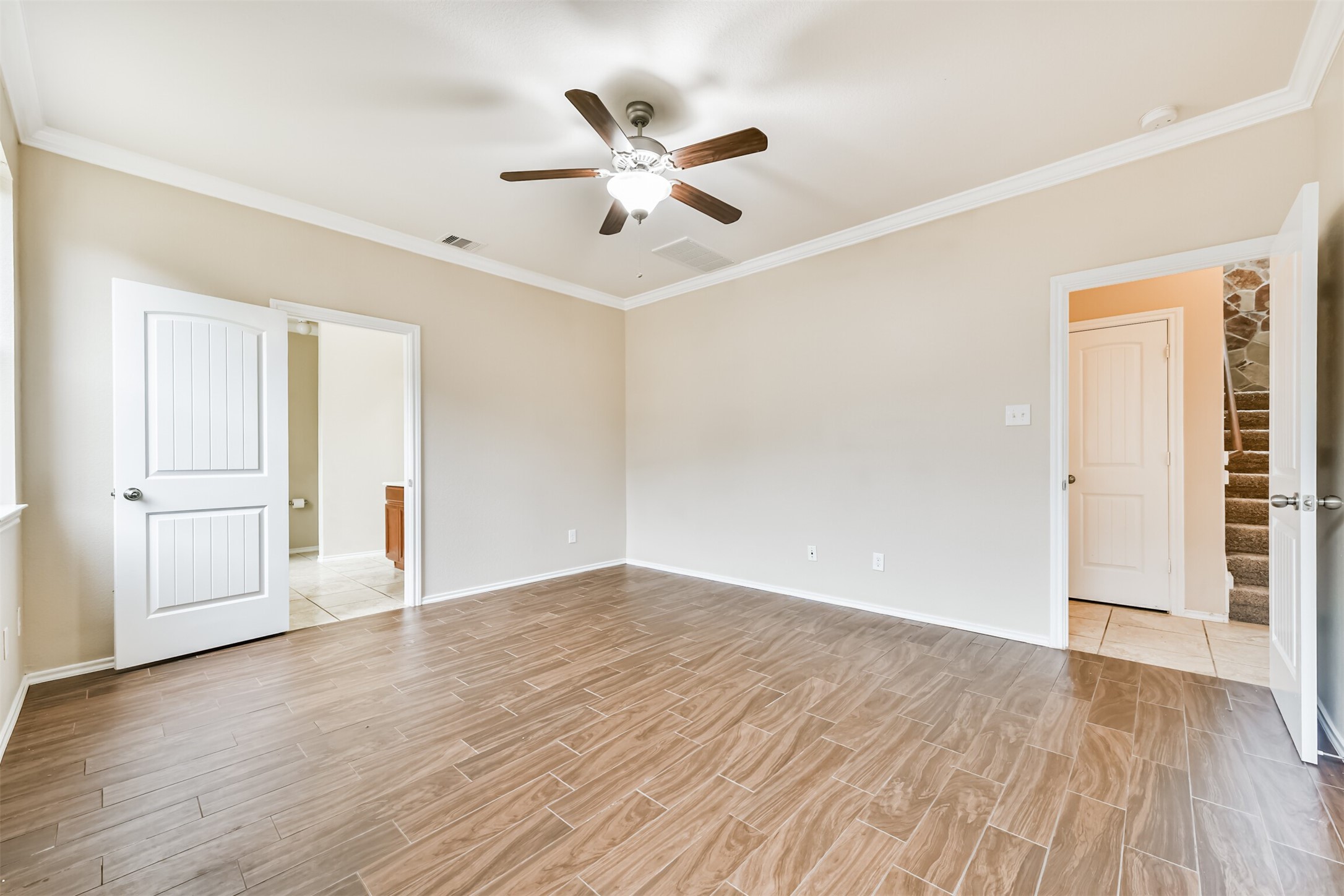 3041 Heather Grove Lane Dickinson, TX 77539 - Photo 20 of 37 an empty room with wooden floor ceiling fan and windows
