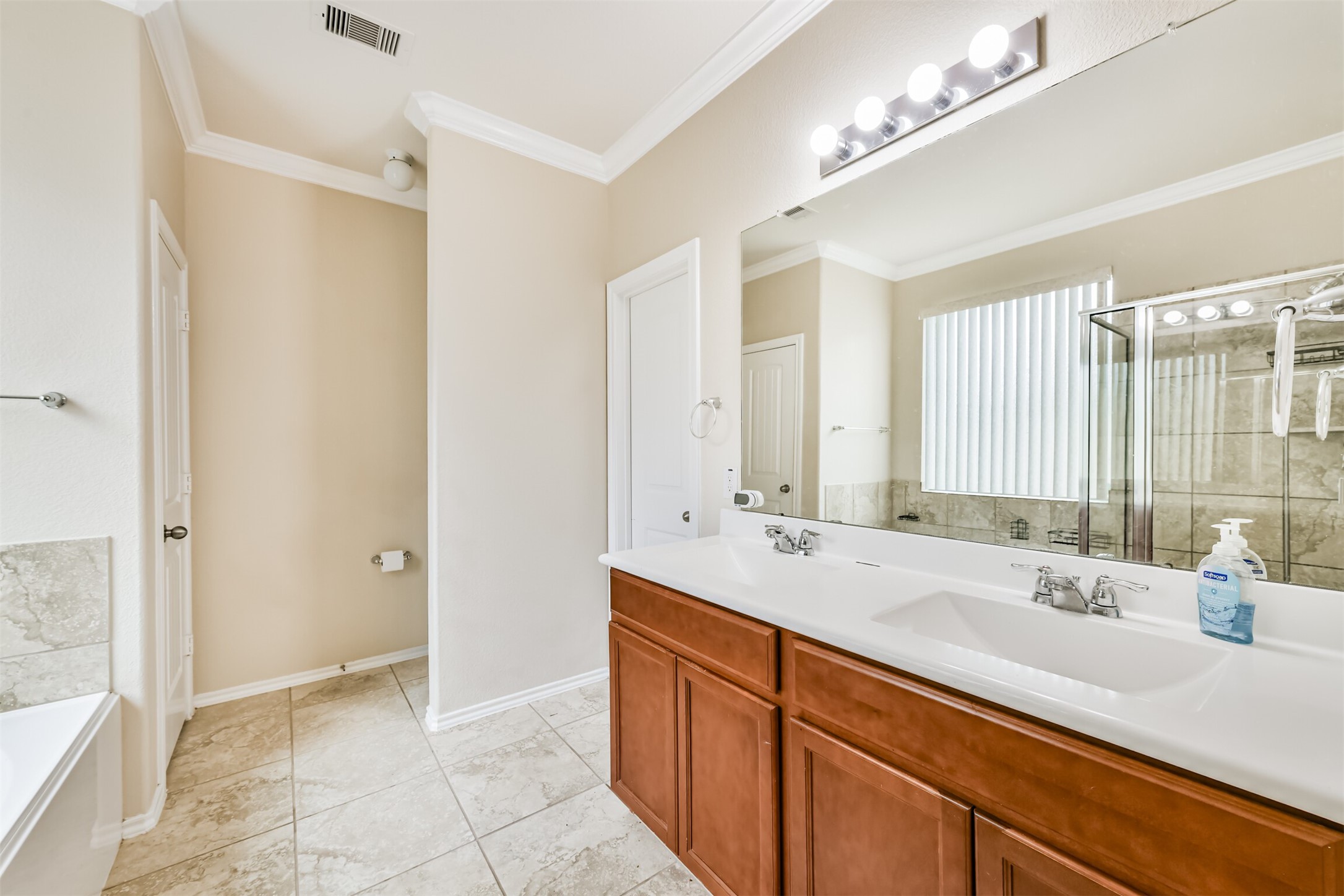 3041 Heather Grove Lane Dickinson, TX 77539 - Photo 21 of 37 a bathroom with a sink double vanity and a mirror