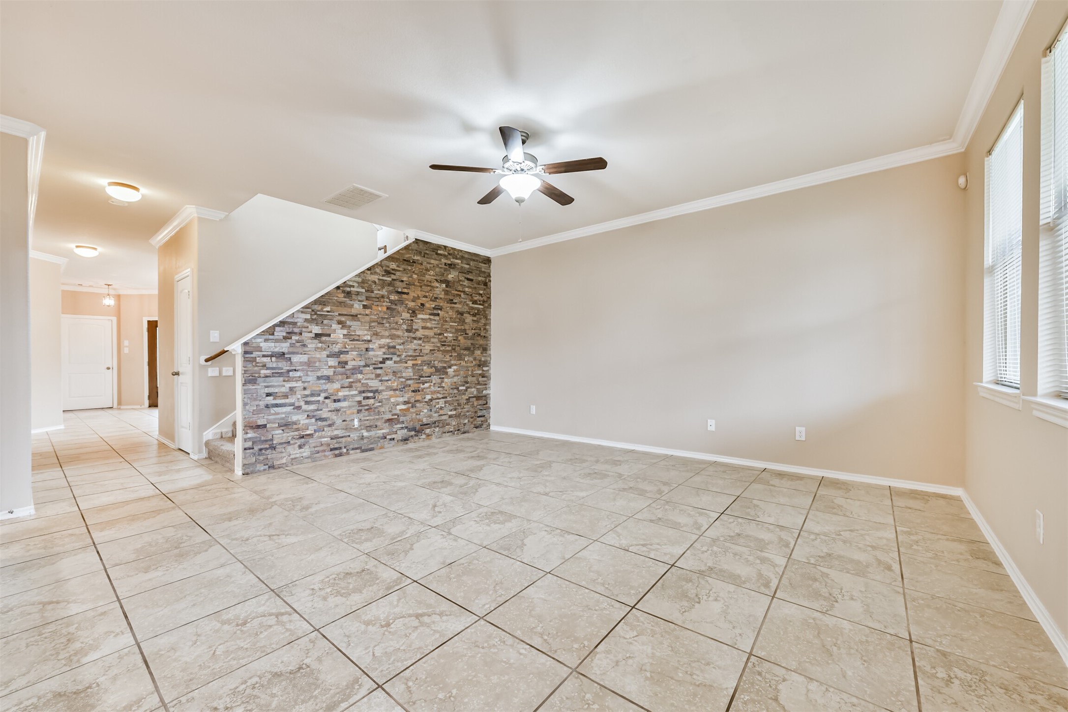 3041 Heather Grove Lane Dickinson, TX 77539 - Photo 9 of 37 an empty room with windows and chandelier fan