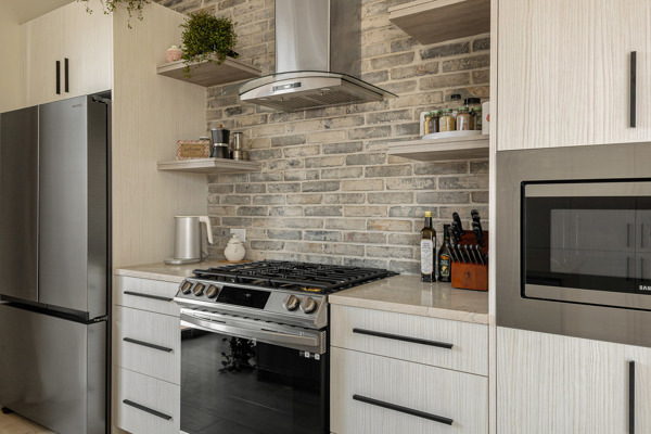 2135 West Cermak Road, Unit 3S Chicago, IL 60608 - Photo 5 of 14 a kitchen with granite countertop a stove and a refrigerator
