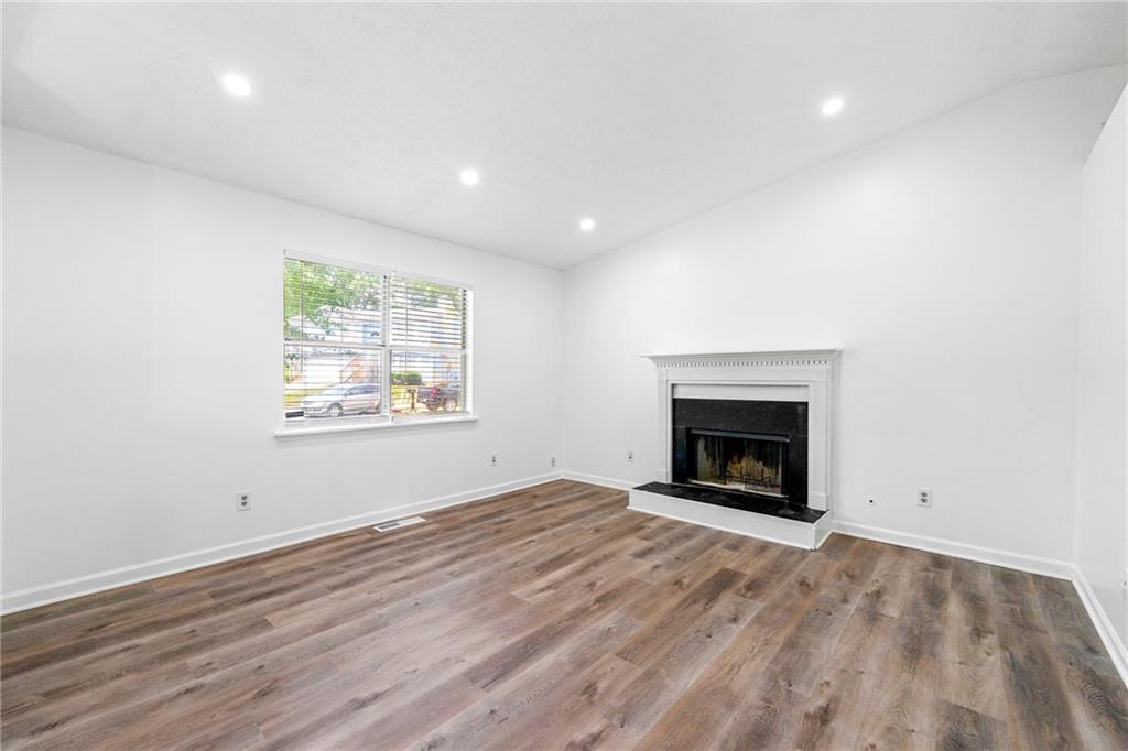 2290 Wilkins Cove Decatur, GA 30035 - Photo 17 of 21 an empty room with windows and fireplace