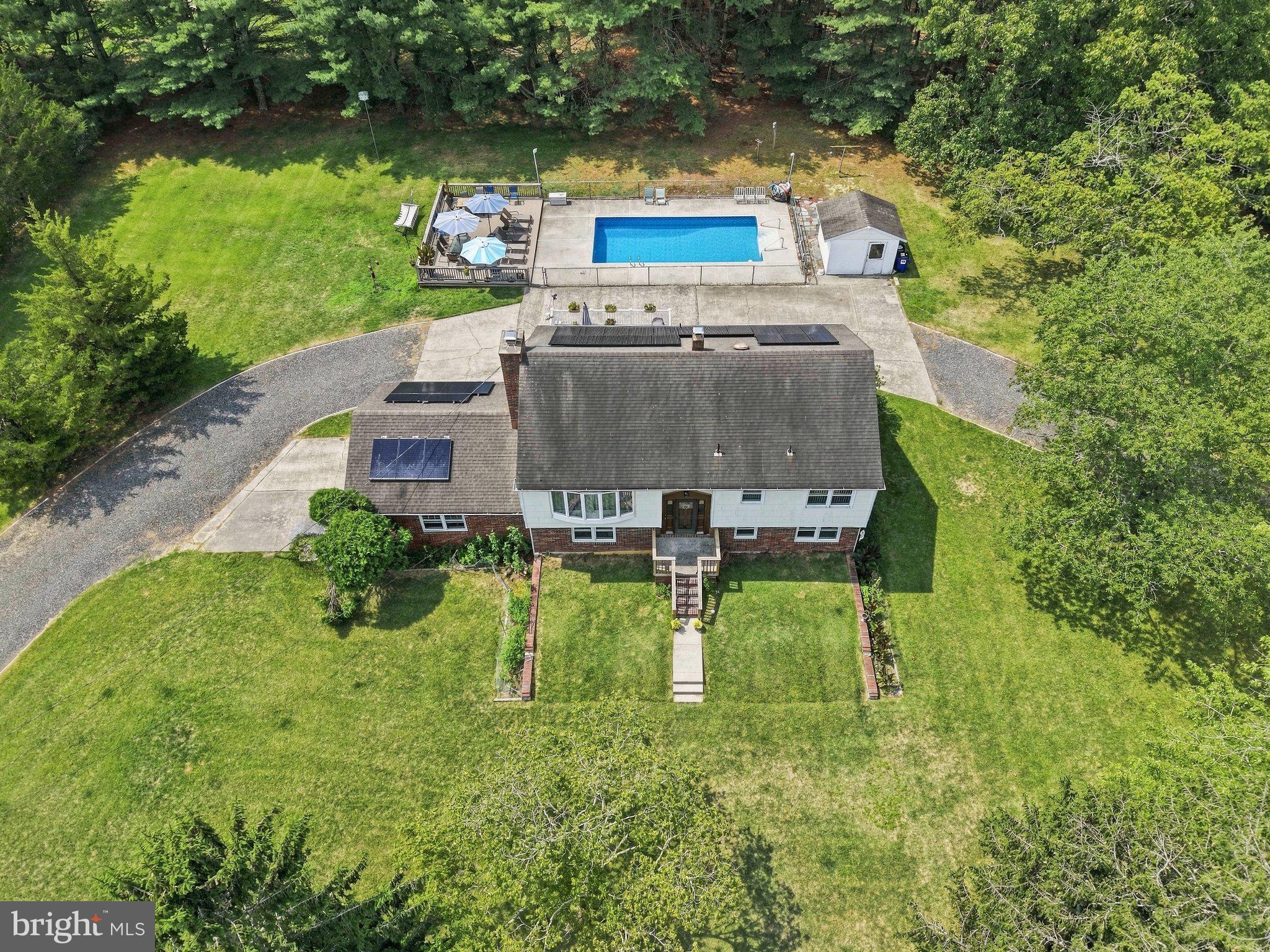 Serene home with pool and lush grounds.