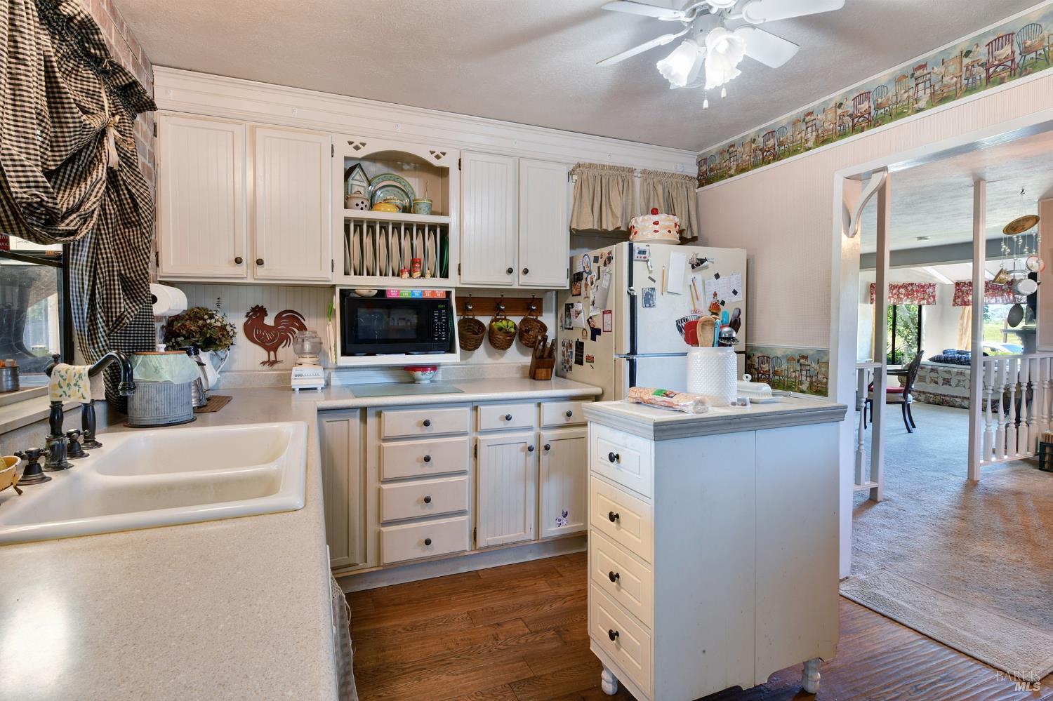 148 Millbrae Avenue Santa Rosa, CA 95407 - Photo 14 of 29 a kitchen with cabinets stainless steel appliances and wooden floor