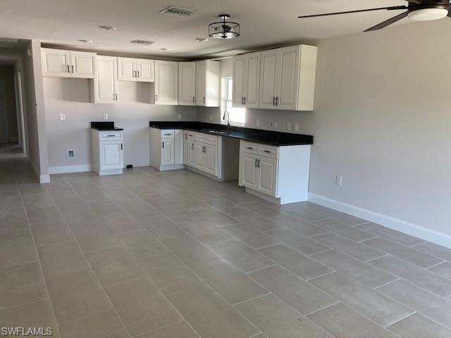 3838 Kelly Street Fort Myers, FL 33901 - Photo 3 of 15 a kitchen with granite countertop a sink and cabinets