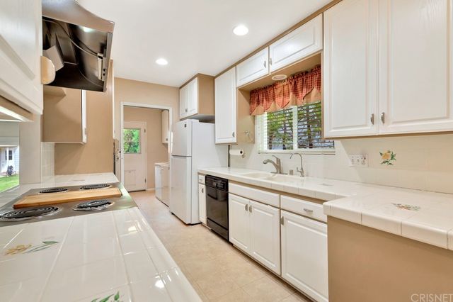 a kitchen with a sink stove and cabinets
