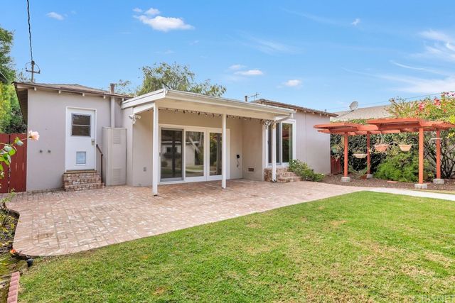 a view of a house with a yard and porch