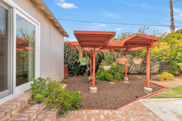 a view of a backyard with potted plants