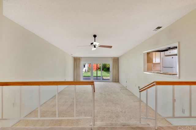 a view of a livingroom with a ceiling fan and window