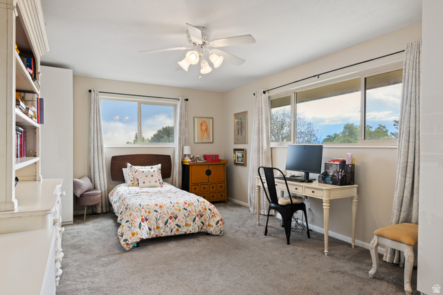 3320 Cherokee Lane Provo, UT 84604 - Photo 25 of 52 Carpeted room featuring a ceiling fan with integrated lighting, multiple windows, and built-in shelving