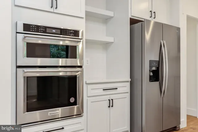 a kitchen with cabinets and stainless steel appliances