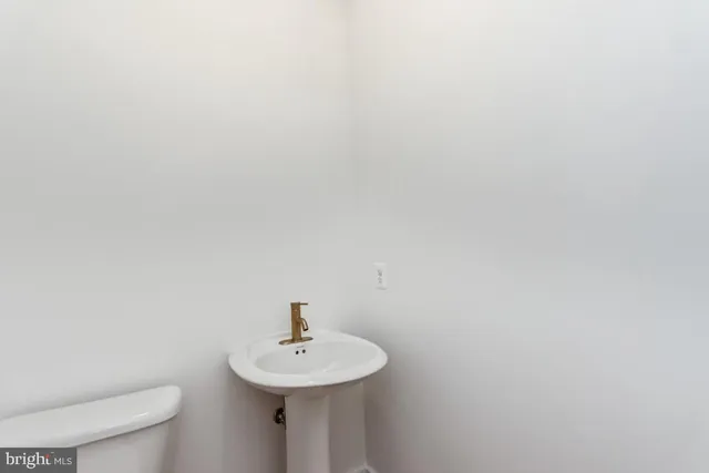 a bathroom with a sink a toilet and mirror