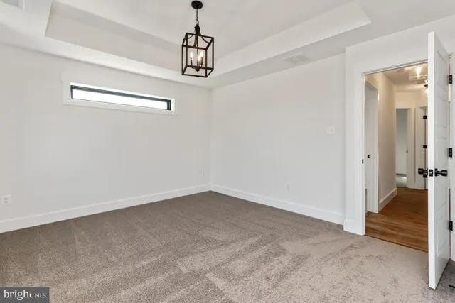 a view of a livingroom with a ceiling fan & entryway