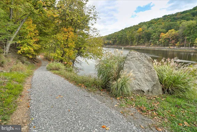 a view of a lake with beach and mountain view