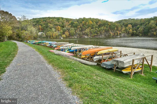 a view of a lake with lawn chairs
