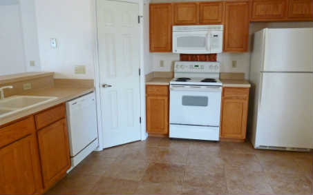 96050 Starlight Lane Yulee, FL 32097 - Photo 16 of 24 a kitchen with a stove cabinets and refrigerator