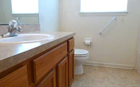 96050 Starlight Lane Yulee, FL 32097 - Photo 10 of 24 a bathroom with a sink a toilet and a mirror