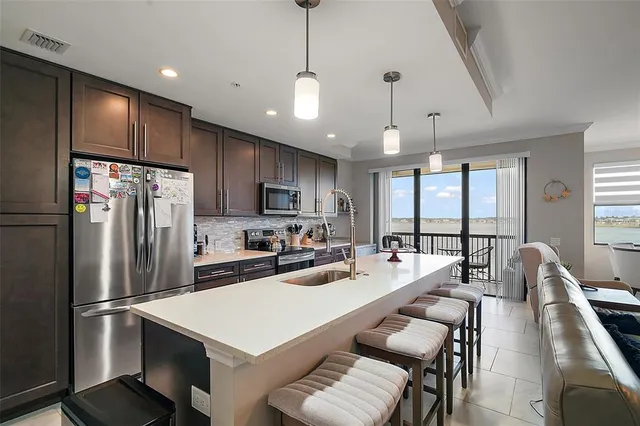 a kitchen with a stove sink and a refrigerator